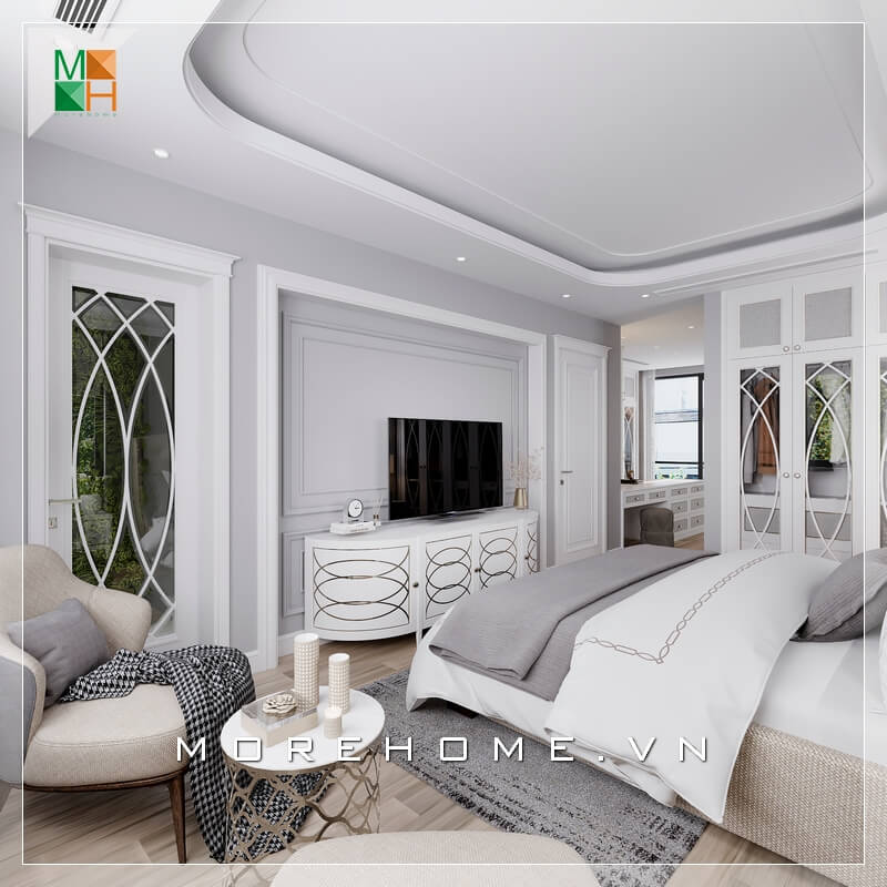 Đan xen giữa sắc trắng chủ đạo của căn phòng ngủ là bộ bàn 1 ghế sofa màu kem rất sang trọng làm tăng độ tiện nghi cho căn phòng ngủ tân cổ điển