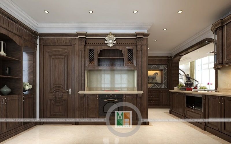 Thiết kế phòng bếp chung cư tân cổ điển có hệ tủ bếp gỗ tự nhiên nâu trầm với kiểu dáng tinh tế, nghệ thuật mang đến vẻ đẹp sang trọng, đẳng cấp cho căn phòng.